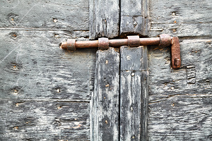 Wooden door with rusty latch in Pienza Val dOrcia Tuscany by Marco Brivio