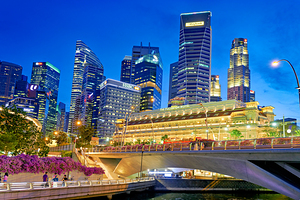 People walk by the waterfront in Marina Bay during sunset in Sin by Marco Brivio