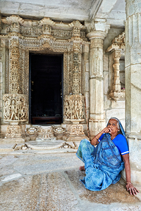 Old Jain temples in Ranakpur Rajasthan with a woman resting