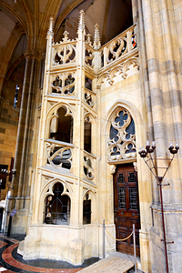 Ornate Gothic stone structure and door inside a cathedral. by Marco Brivio