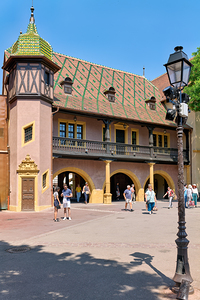 Visitors walk near the historic Koifhus house in Colmar on a sun by Marco Brivio