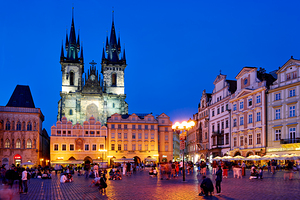 Pragues Old Town Square Týn Church bustling at night. by Marco Brivio