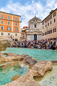 Crowd enjoys the lively atmosphere at Trevi Fountain in Rome