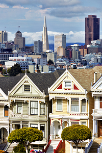 Colorful houses in Alamo Square with city view by Marco Brivio