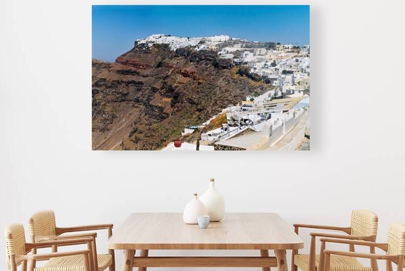Santorinis white village on volcanic cliff. by Marco Brivio