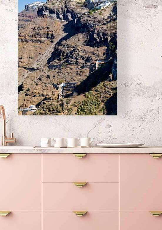 Santorini cliffside town with cable car and winding paths. by Marco Brivio