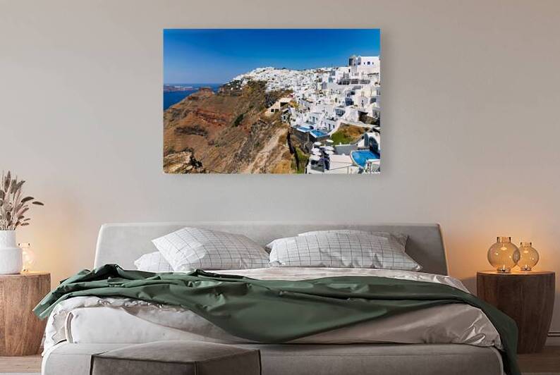 Santorini: White cliffside village blue sea clear sky. by Marco Brivio