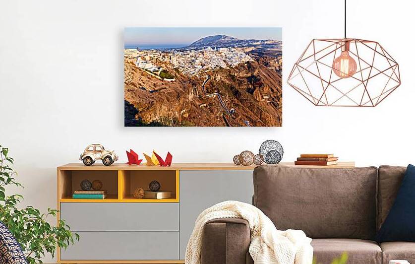 Santorinis Fira town on caldera cliff at sunset. by Marco Brivio