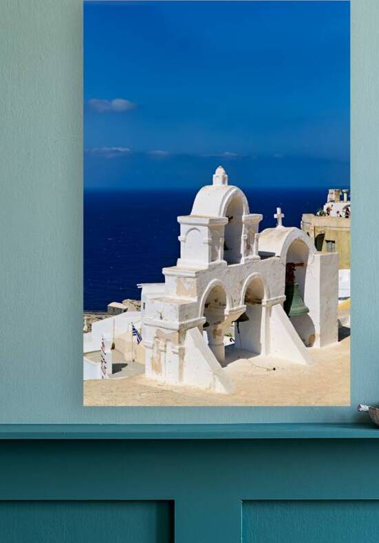 Santorinis iconic white bell tower against the blue Aegean. by Marco Brivio