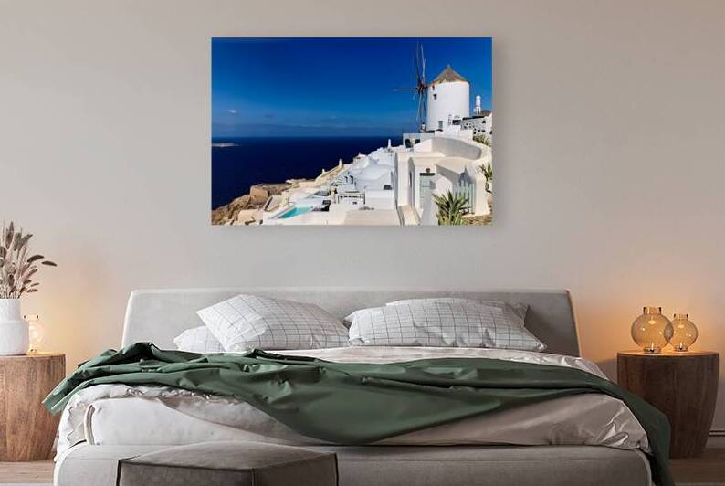 Santorinis iconic white architecture and windmill against the d by Marco Brivio