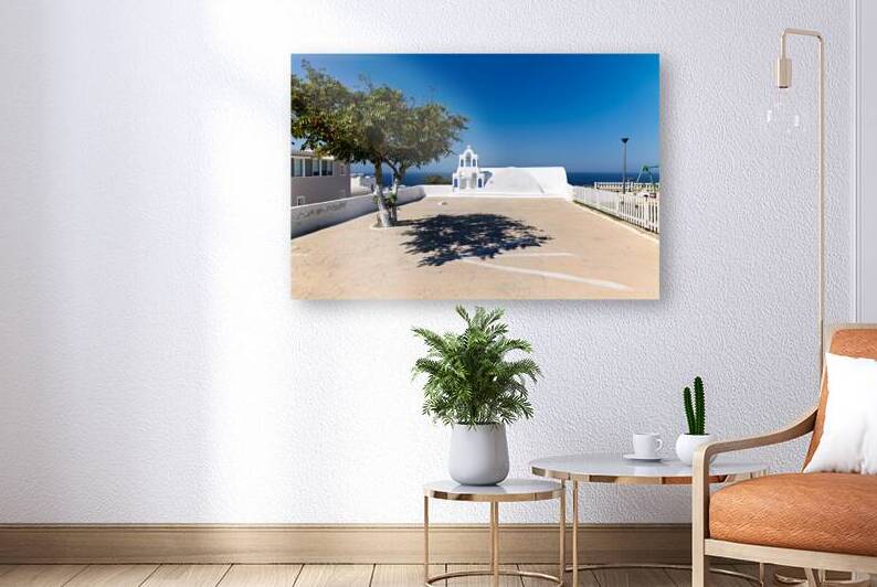 Iconic white church green tree and blue sea in Greece. by Marco Brivio