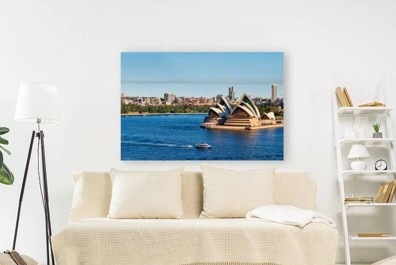 Sydney Opera House and harbor with ferry on a sunny day. by Marco Brivio