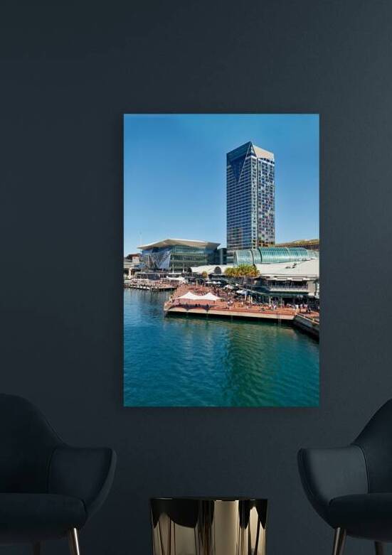 Modern buildings and waterfront promenade with people enjoying t by Marco Brivio