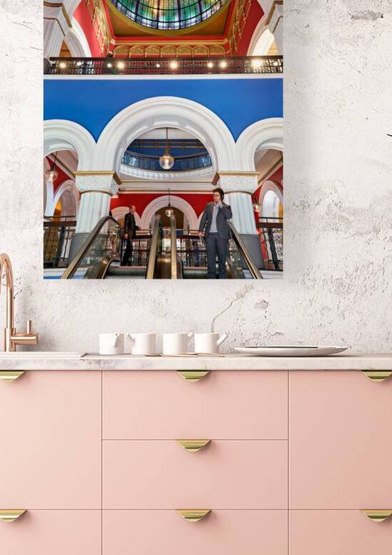 Men ride escalators in Queen Victoria Building in Sydney by Marco Brivio