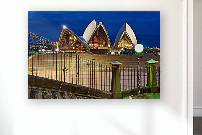 Sydney Opera House illuminated at dusk with crowds on steps. by Marco Brivio
