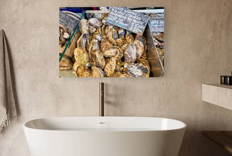 Fresh oysters for sale at a market stall. by Marco Brivio