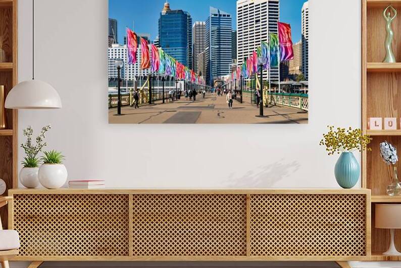 Colorful flags line bridge in Darling Harbour Sydney on a sunny  by Marco Brivio