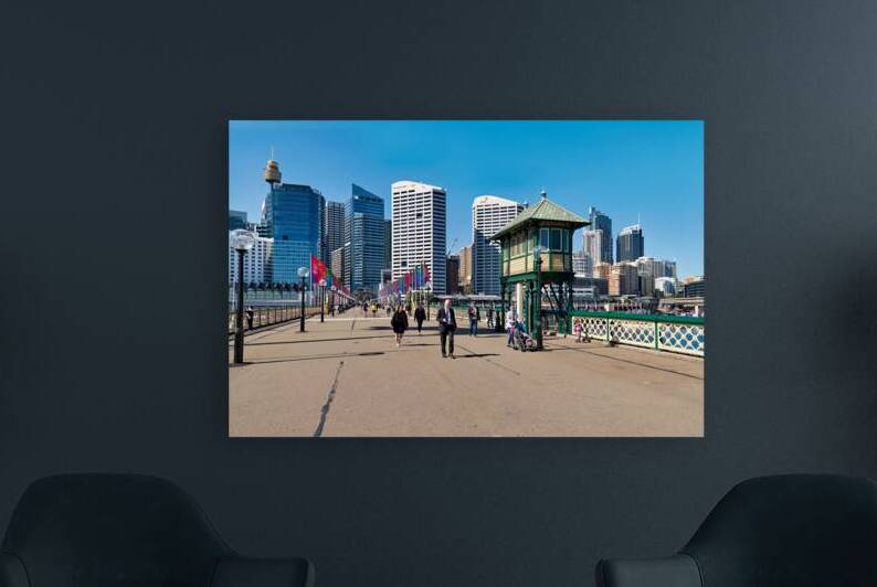 People walk on a sunny day with Sydney skyline. by Marco Brivio