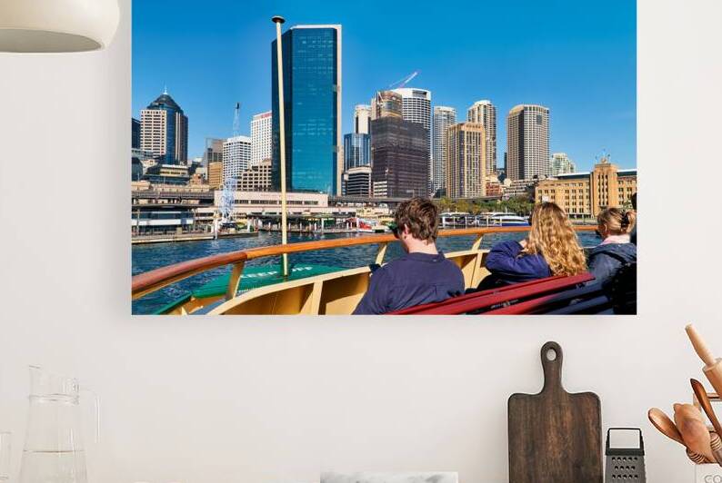 Ferry passengers enjoy city skyline view. by Marco Brivio