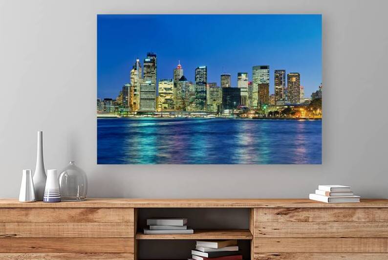 Sydney skyline at dusk with illuminated buildings and water. by Marco Brivio