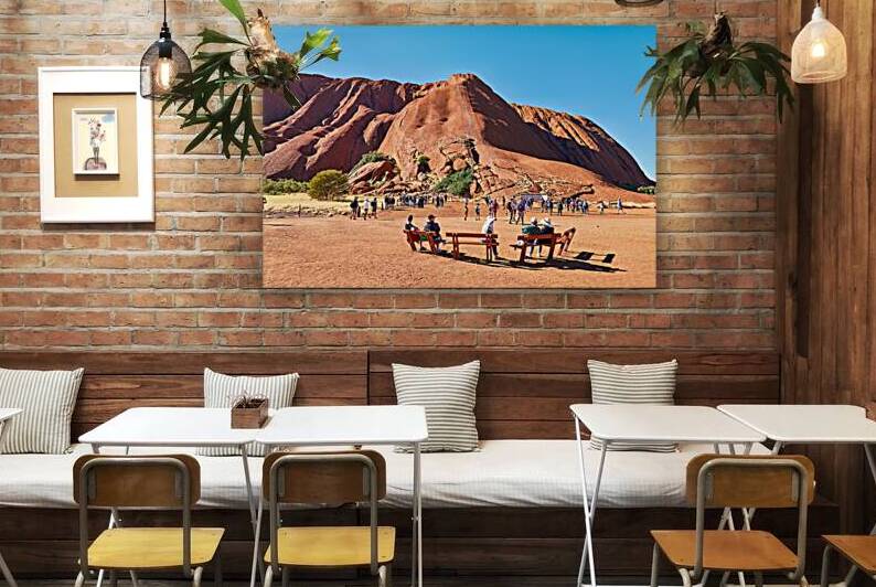 Tourists gather at the base of Uluru Australia. by Marco Brivio
