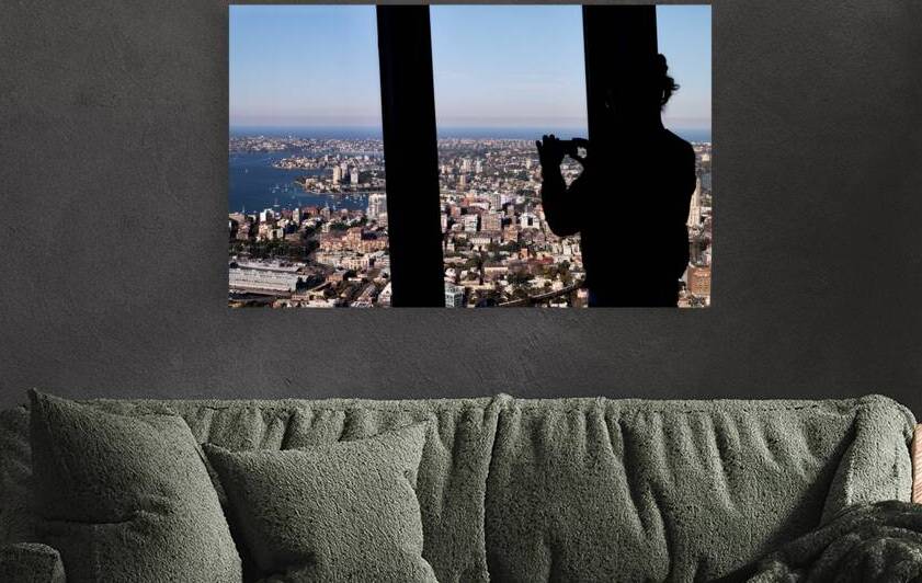 Silhouette of person taking photo of Sydney cityscape. by Marco Brivio