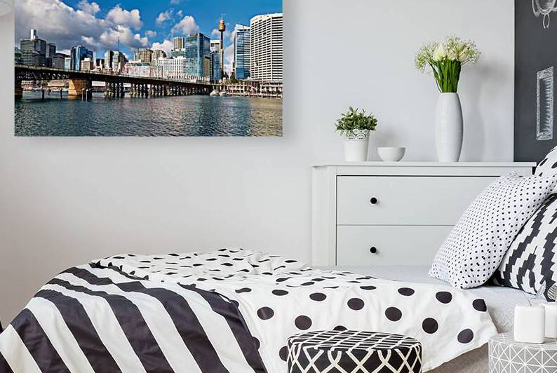 View of Sydney Harbour with bridge and city under blue sky by Marco Brivio