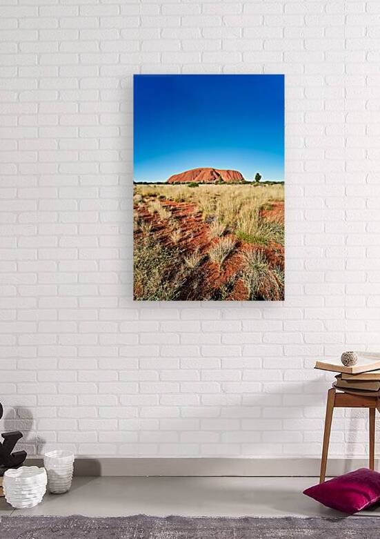 Uluru Australia: A vast red desert landscape under a clear blue by Marco Brivio