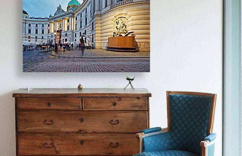 Illuminated Hofburg Palace Vienna with people and horse carria by Marco Brivio