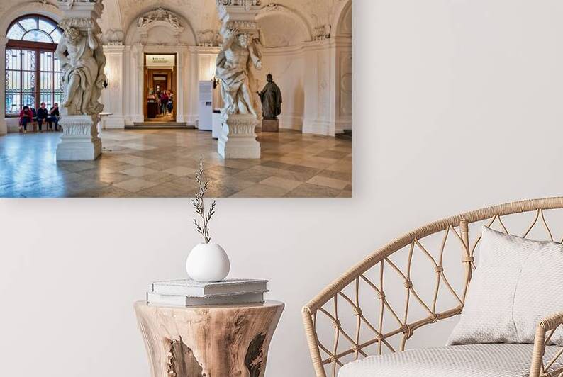 Ornate Baroque hall with sculptures and visitors. by Marco Brivio