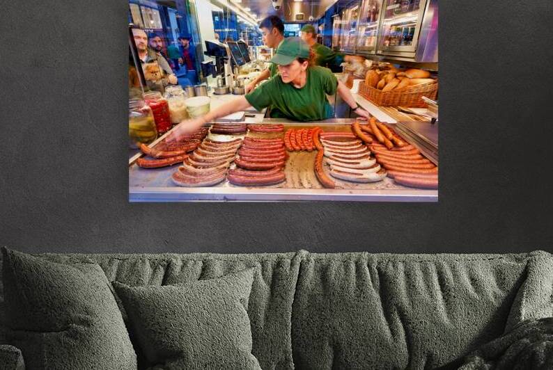 Sausages cooking at a busy street food stand. by Marco Brivio