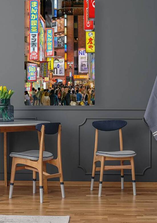 Nighttime crowd under neon lights in Shibuya district in Tokyo by Marco Brivio