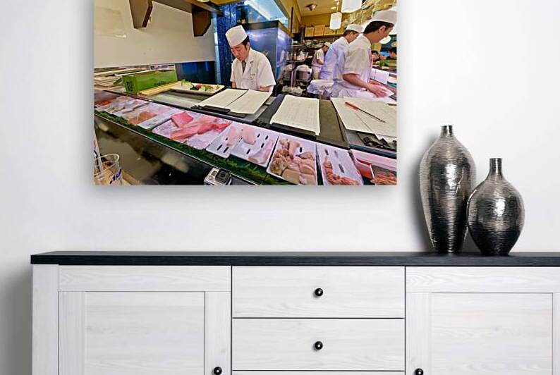 Sushi chefs preparing fresh dishes in Shibuya district of Tokyo by Marco Brivio