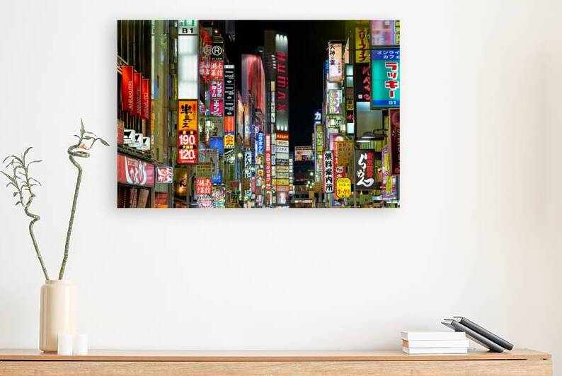 Neon lights shining in Shinjuku district of Tokyo during nightti by Marco Brivio