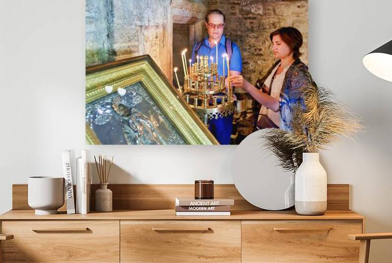 Visitors light candles in a historic religious site in Greece by Marco Brivio