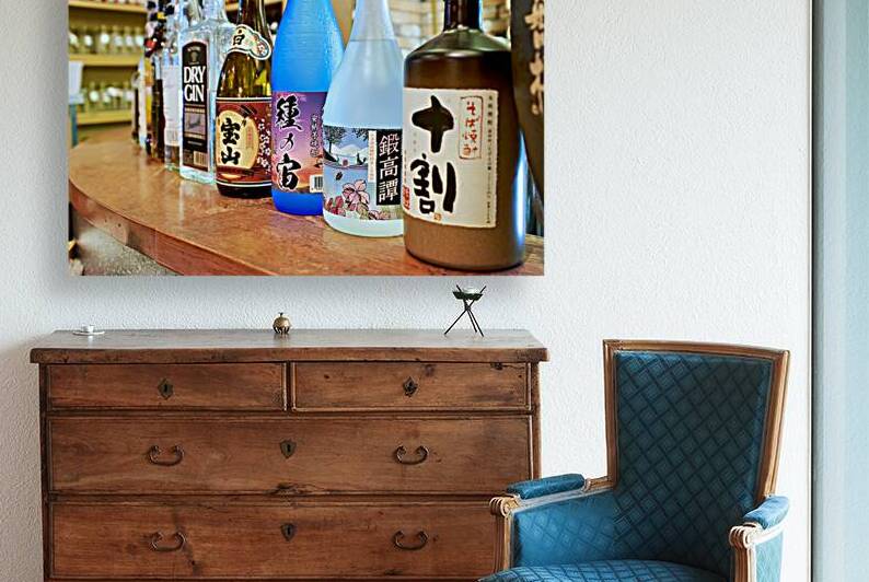 Sake bottles displayed on a counter in Kyoto Japan by Marco Brivio