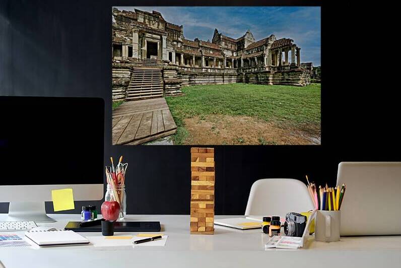 Ancient stone temple ruins wooden stairs green lawn blue sky. by Marco Brivio