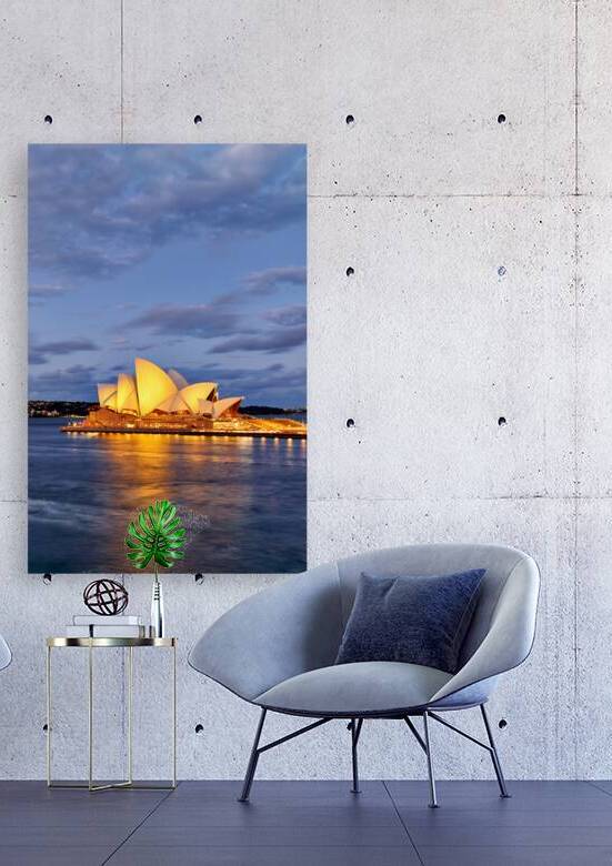 Sydney Opera House illuminated at dusk with harbor reflections. by Marco Brivio