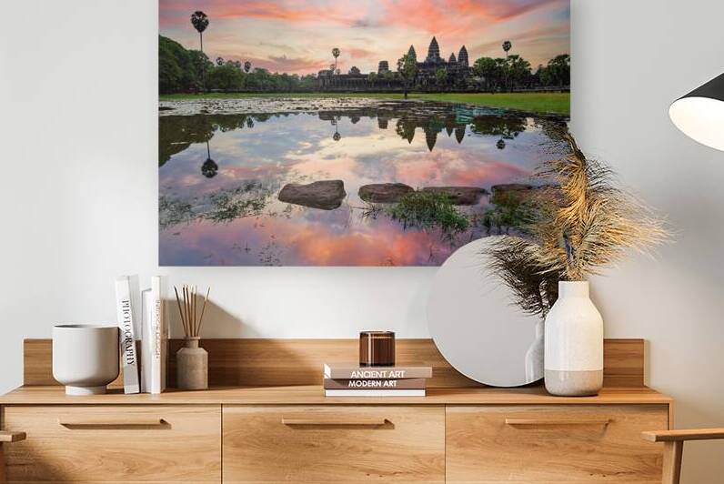 Angkor Wat temple reflected in water at sunset. by Marco Brivio