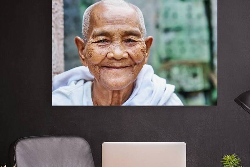 Smiling elderly Asian woman with shaved head. by Marco Brivio