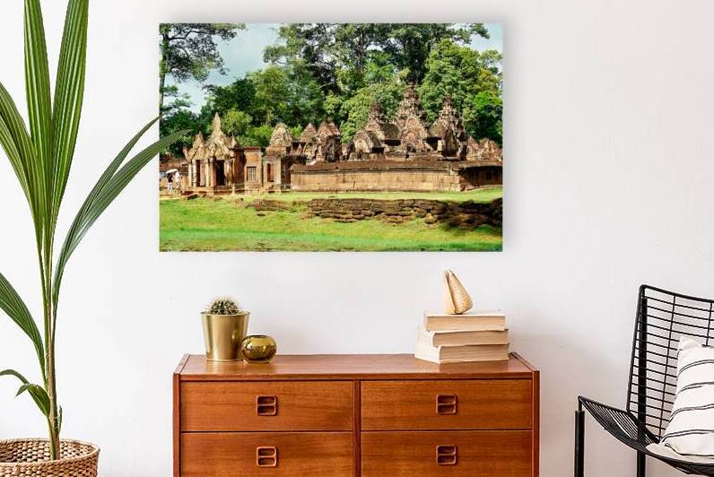 Ancient stone temple complex surrounded by lush jungle and water by Marco Brivio