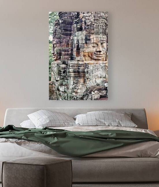 Ancient stone faces carved into a temple wall. by Marco Brivio