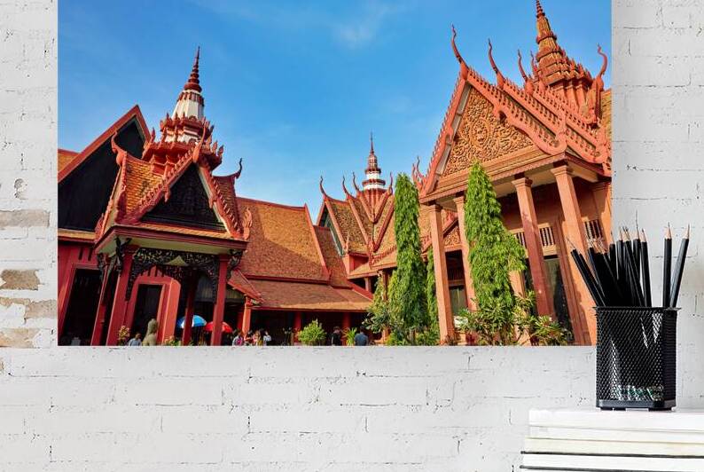 Ornate Cambodian temple architecture with red roofs and spires. by Marco Brivio
