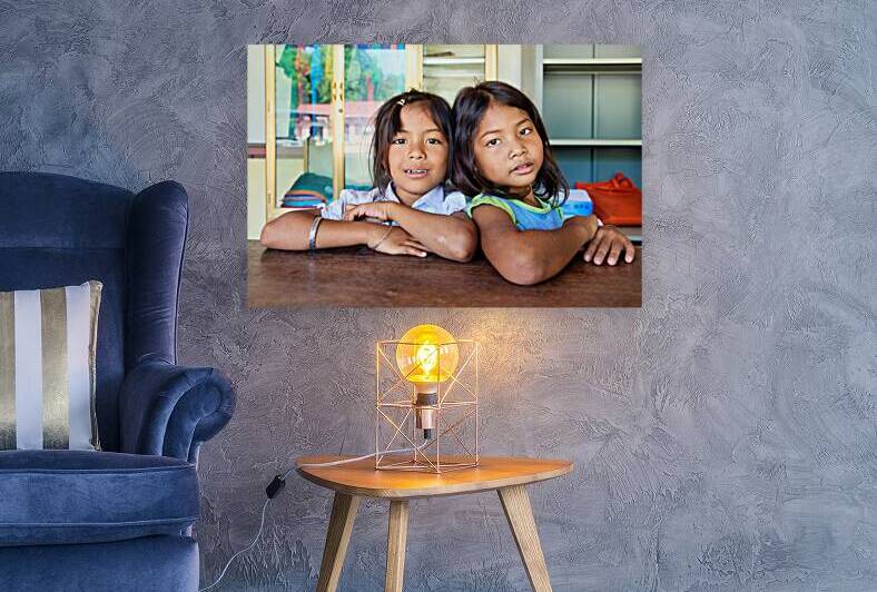 Two young girls pose together looking at the camera. by Marco Brivio