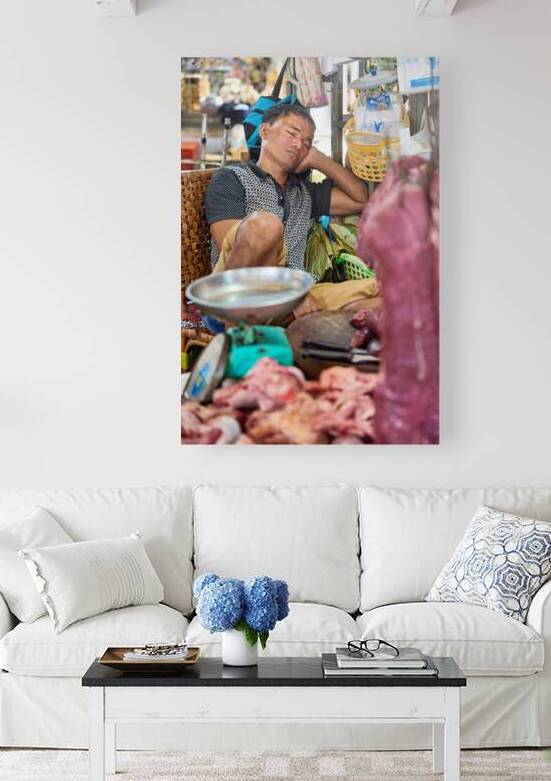 Market vendor sleeping at his meat stall. by Marco Brivio