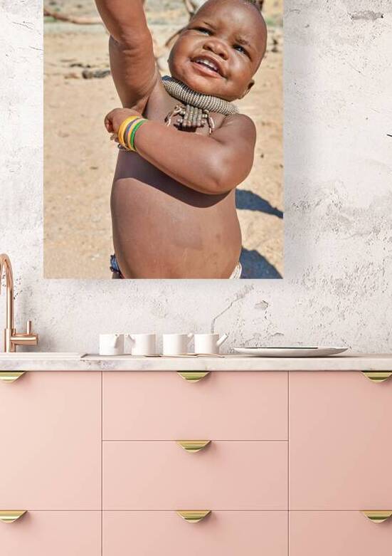 Himba child smiles and poses in the Kunene region of Namibia by Marco Brivio