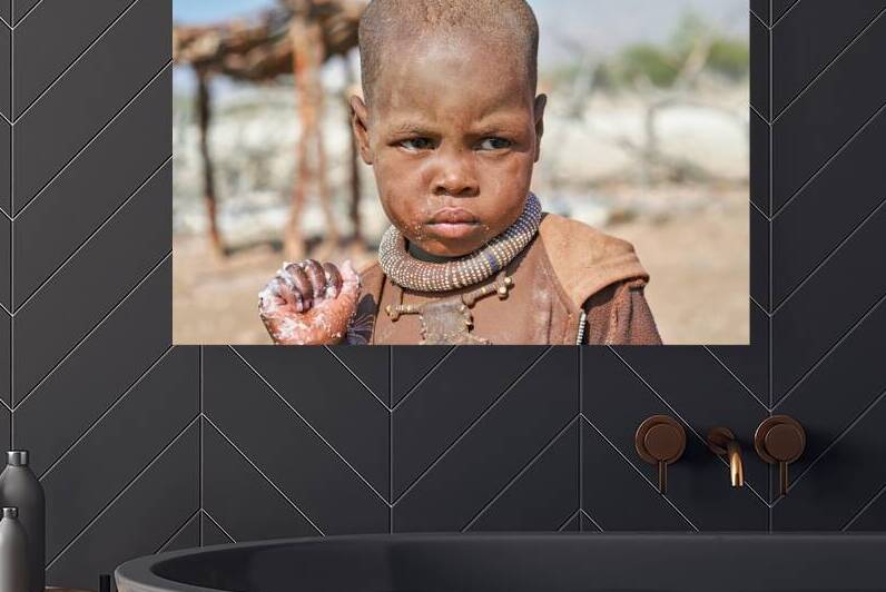Portrait of a child from Himba Village in Kunene Region of Namib by Marco Brivio