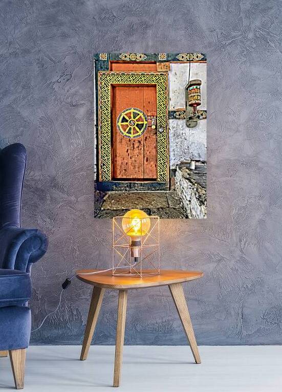 Colorful Bhutanese door with Dharma wheel and prayer wheel. by Marco Brivio