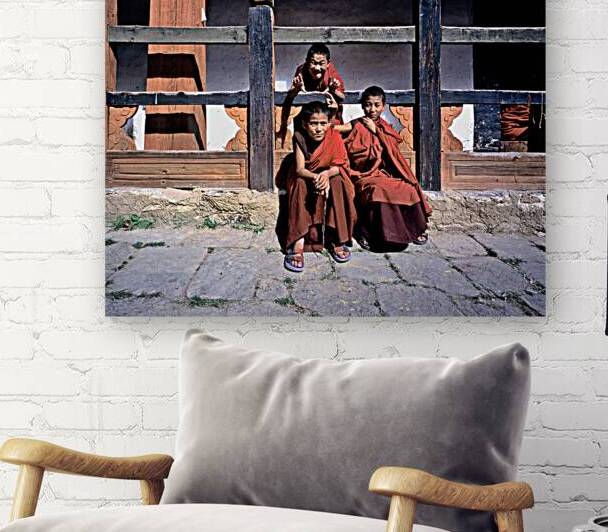 Three young monks playfully pose. by Marco Brivio