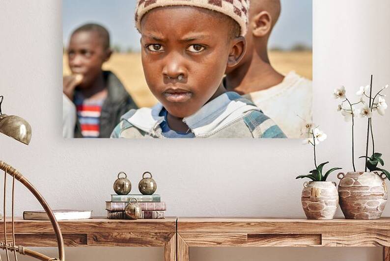 Portrait of a boy in Kavango Region Namibia during the day by Marco Brivio